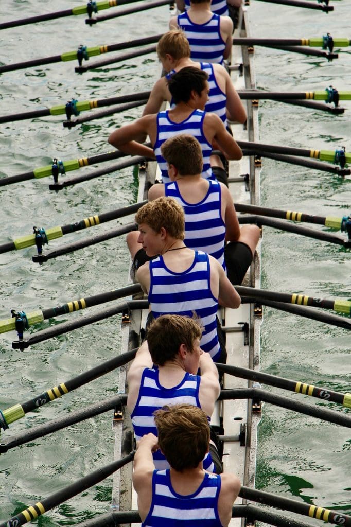 rowers on a boat in blue and white stripey tops
