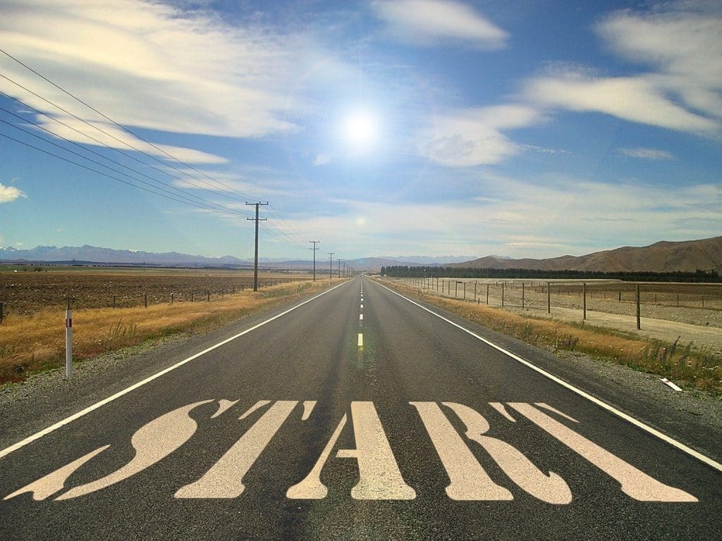 Image of a road going off into the distance with blue sky and clouds. Writing on the bottom says 'start' which sort of looks like a zebra crossing and shows how to plan an away day by starting
