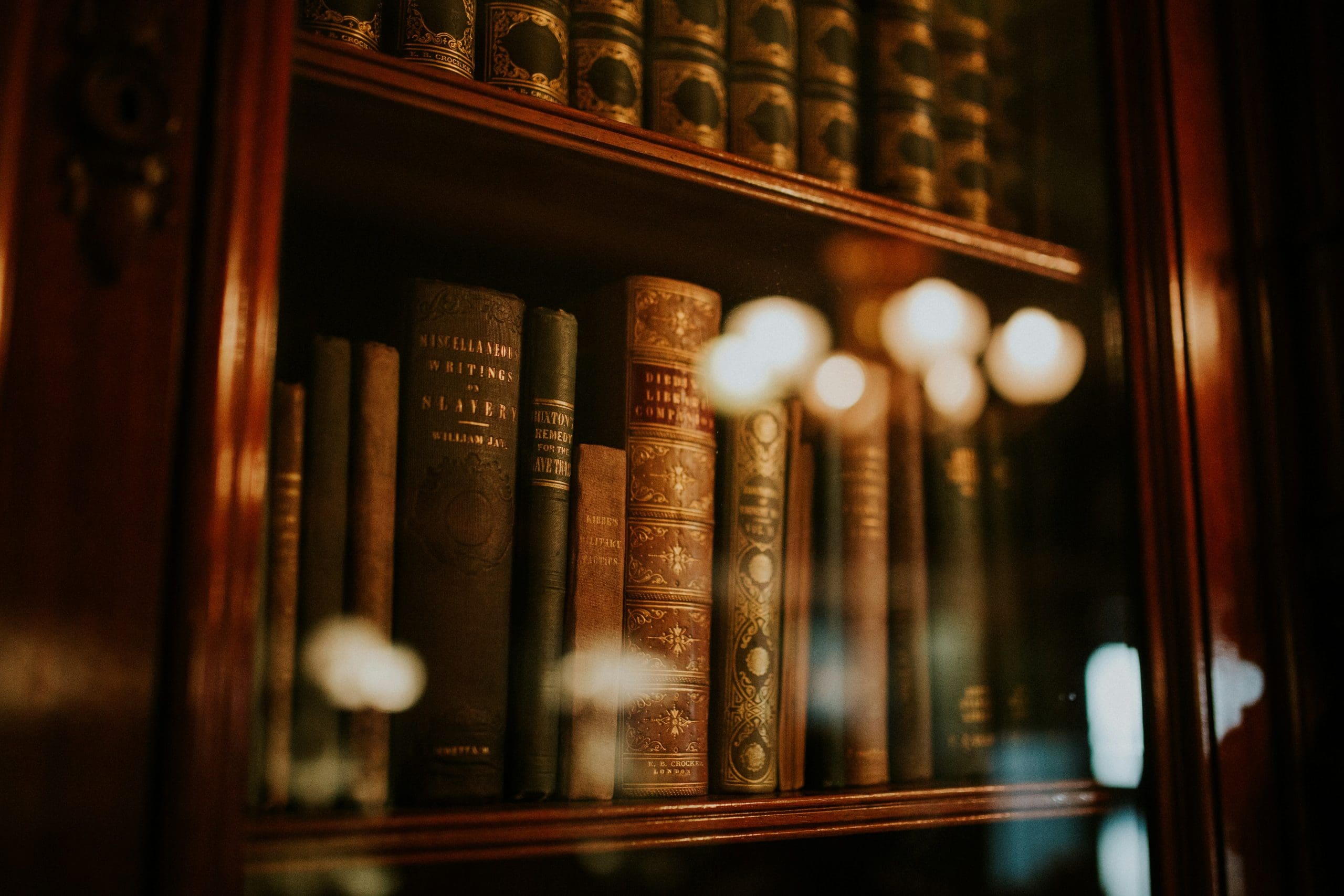 Some old books behind a glass cabinet door showing how strategies sometimes get locked away which is why regular strategy development is useful
